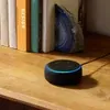 Amazon Echo Dot 3rd Gen smart speaker in Black, on a bookshelf
