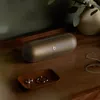 Beats Pill portable Bluetooth speaker in Champagne Gold, indoors on wooden furniture