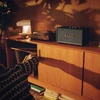 Marshall Stanmore III Bluetooth home speaker in Black, on a sideboard next to a record player