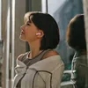 Sennheiser Accentum Open true wireless open-fit earbuds in Sakura, worn by a woman, side view