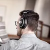 Sennheiser HD 599 SE open-back headphones in Black, worn while reading a record sleeve