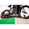 JBL Charge 6 portable Bluetooth speaker in Squad, on a skate park ledge beside a BMX bike