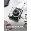 Fujifilm Instax Mini 99 Premium Edition Pack, Silver, camera on a table with instant prints