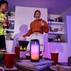 JBL Pulse 4 portable Bluetooth speaker in Black, on a party table