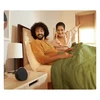 Amazon Echo Pop smart speaker in Black, on a bedside table