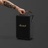 Marshall Tufton portable Bluetooth speaker in Black and Brass, carried by the strap