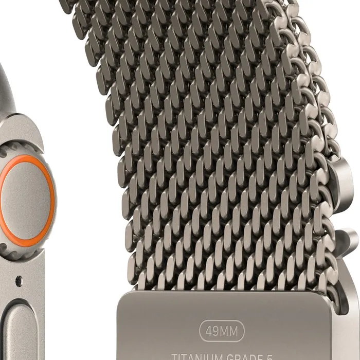 Apple Watch Ultra 4 in Natural Titanium with the Natural Titanium Milanese Loop, close-up of the Digital Crown, side button and titanium mesh and buckle