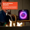 JBL PartyBox Encore Essential 2 Bluetooth party speaker in Black, lit up beside a fire pit at an evening gathering
