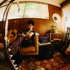 Marshall Acton III Hendrix Edition Bluetooth home speaker in Purple and Black, in a living room with guitars