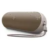Beats Pill portable Bluetooth speaker in Champagne Gold, angled view with the lanyard attached and water drops