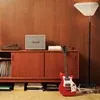 Marshall Woburn III Bluetooth home speaker in Cream, on a sideboard next to a record player