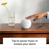 Amazon Echo Dot 5th Gen smart speaker in White, tap to pause on a side table
