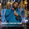 Marshall Willen II portable Bluetooth speaker in Black and Brass, hanging from a bag strap