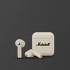 Marshall Minor IV true wireless earbuds in Cream, earbuds beside the closed charging case