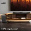 JBL Bar 2.1 Essential soundbar with wireless subwoofer in Black, on a TV unit below a wall-mounted TV