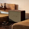 Marshall Woburn III Bluetooth home speaker in Brown, beside a bed