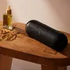 Beats Pill portable Bluetooth speaker in Matte Black, with water drops on its surface