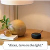 Amazon Echo Dot 3rd Gen smart speaker in Black, on a bedside table
