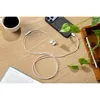 Sennheiser CX 80U USB-C wired earphones in White, plugged into a phone on a desk