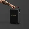 Marshall Tufton portable Bluetooth speaker in Black and Brass, carried by the strap