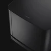 Bose Bass Module 500 wireless subwoofer in Black, close-up of the top edge and Bose logo
