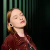JBL Live Beam 3 noise cancelling earbuds in Black, worn by a woman listening with eyes closed