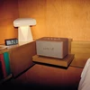 Marshall Acton III Bluetooth home speaker in Brown, on a bedside table
