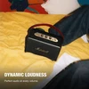 Marshall Kilburn III portable Bluetooth speaker in Black and Brass, on a bed beside a person