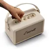 Marshall Kilburn III portable Bluetooth speaker in Cream, hand turning the volume knob