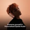 Apple AirPods Max (USB-C) in Orange, worn by a listener