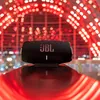 JBL Xtreme 4 portable Bluetooth speaker in Black, on a glossy surface at night