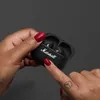 Marshall Motif II A.N.C. true wireless noise cancelling earbuds in Black, charging case held in the hand