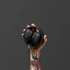 Marshall Major IV wireless on-ear headphones in Black, folded and held in one hand