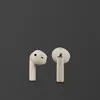 Marshall Minor IV true wireless earbuds in Cream, both earbuds, inner and outer side