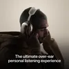 Apple AirPods Max (USB-C) in Starlight, worn by a listener