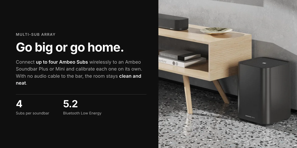 Sennheiser Ambeo Sub beside a TV stand, up to four Subs wirelessly with Ambeo Soundbar Plus or Mini