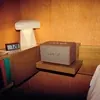 Marshall Acton III Bluetooth home speaker in Brown, on a bedside table