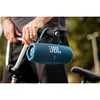 JBL Charge 6 portable Bluetooth speaker in Blue, hanging from bicycle handlebars by its strap