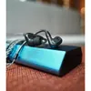 Sennheiser IE 200 wired in-ear monitors, Black, resting on a portable DAC
