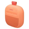 Bose SoundLink Micro (2nd Gen) portable Bluetooth speaker in Sunset Peach, angled view from the left