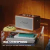 Marshall Kilburn III portable Bluetooth speaker in Brown, on a clear acrylic side table with books