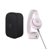 Beats Solo 4 on-ear wireless headphones in Cloud Pink, next to the carrying case with the cable connected