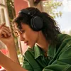 Sennheiser Accentum Plus Wireless noise cancelling headphones in Black, worn by a woman in a green shirt