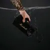 Marshall Middleton portable Bluetooth speaker in Black and Brass, held under water