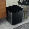 Bose Bass Module 700 wireless subwoofer in Black, on the floor beside a sideboard in a living room