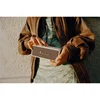 Marshall Emberton II portable Bluetooth speaker in Cream, held in both hands