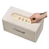 Marshall Stanmore IV Bluetooth home speaker in Cream, hand pulling the power switch on the top panel
