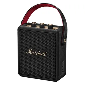 Marshall Stockwell III portable Bluetooth speaker in Black and Brass, angled front view with the carry strap