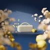 Bose SoundLink Max portable Bluetooth speaker in Citrus Yellow, on a table among flowers