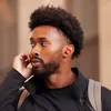 Beats Solo Buds true wireless earbuds in Transparent Red, worn in the ear